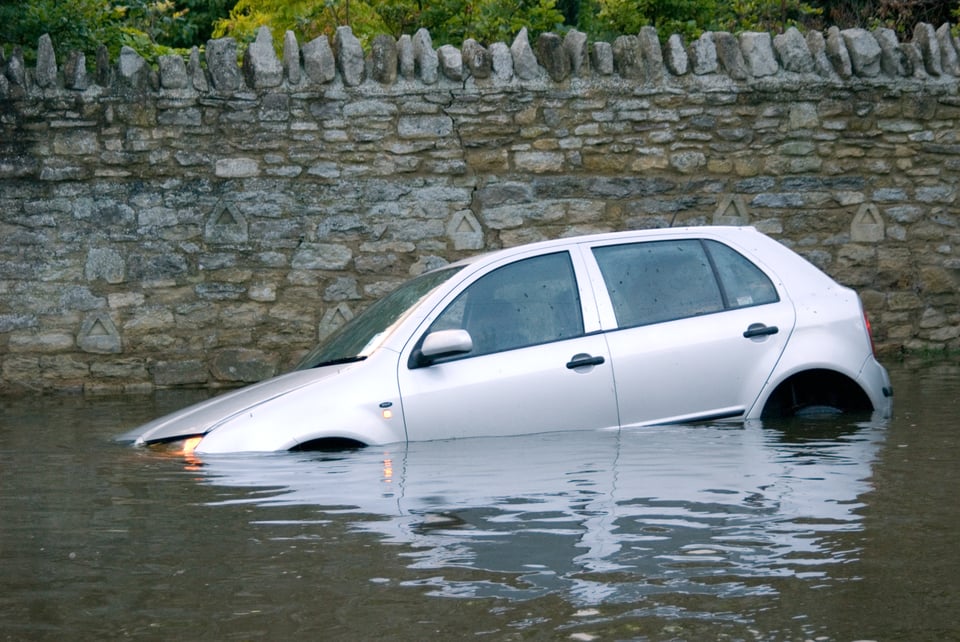 A small SUV in a flood.