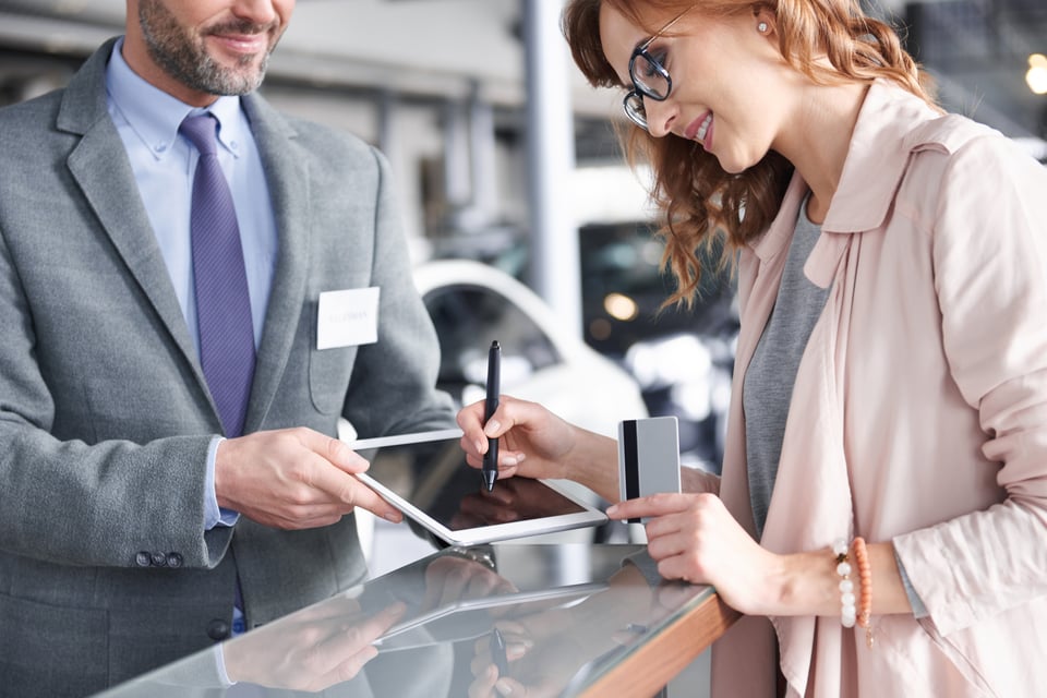A customer singing-in and handing their ID to a dealer